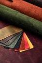 Artificial leather samples on a cow leather background. Top view. Royalty Free Stock Photo