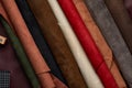 Artificial leather samples on a cow leather background. Top view. Royalty Free Stock Photo