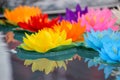 Artificial lotus flowers in various colors floating on the water surface with beautiful reflection. Royalty Free Stock Photo