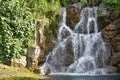 An artificial man made low waterfall under the midday sun Royalty Free Stock Photo
