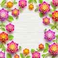 Artificial paper flowers on a white wooden plank background with copy space in the center. Royalty Free Stock Photo