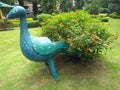 Artificial peacock with tree tail in the greenery filled garden