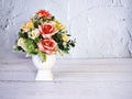 Artificial pink rose flowers bouquet in vase on wooden table copy space text or writing pretty texture background or wallpaper mot Royalty Free Stock Photo