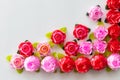 Artificial pink roses red on a white background Royalty Free Stock Photo