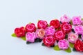 Artificial pink roses red on a white background Royalty Free Stock Photo