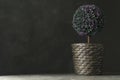 Artificial plant in wicker flower pot on stone table. Space for text Royalty Free Stock Photo