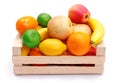 Artificial plastic fruits in wooden crate