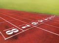 Artificial red autumn treadmill with numbers, running track in the old stadium. Royalty Free Stock Photo