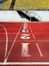 Artificial red autumn treadmill with numbers, running track in the old stadium. Flat background, top view