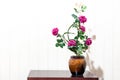 artificial rose Floral Bouquet Flower vase on wood table in whi Royalty Free Stock Photo