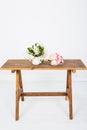 Artificial rose flowers on a white wooden table Royalty Free Stock Photo