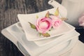 Artificial rose in white plate