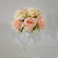 Artificial roses vase flowers on grungy background Royalty Free Stock Photo