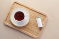 artificial sweetener container and tea cup on table Royalty Free Stock Photo