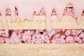 Artificial sweets made from polystyrene foam, layered with pink icing and colorful sprinkles, displayed on a flat surface with a Royalty Free Stock Photo