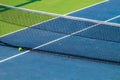 Artificial tennis court. View of the ball lying at the net. Very bright colors