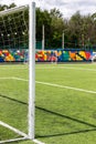 Artificial turf on the football field. Part of the football goal and green synthetic grass on the sports field on the background Royalty Free Stock Photo