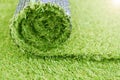 Artificial turf roll. Synthetic grass lawn laying background Royalty Free Stock Photo