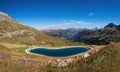 Artificial water catchment reservoir for snow skiing slopes at Dolomites in Italy Royalty Free Stock Photo