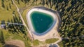 Artificial water catchment reservoir for snow skiing slopes at Dolomites, Italy Royalty Free Stock Photo