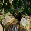 Artificial watercourse gutter in a stone bed in a park