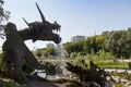 Artificial waterfall from the mouth of a huge dragon decorative composition made from stone and concrete