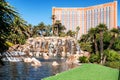 An artificial waterfall and pool with palm trees next to the Mirage Hotel and Casino on the Strip in Las Vegas, Nevada