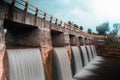 artificial waterfall in the river under bridge Royalty Free Stock Photo