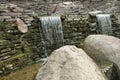 Artificial waterfall. Water runs over the stones Royalty Free Stock Photo