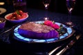 Artificially cultivated meat fillet garnished on a plate with elegant restaurant decor, neon light