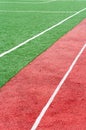 Artificially turfed football field and red synthetic rubber running lines Royalty Free Stock Photo