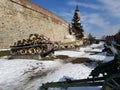 Artillery tank armour war machine park exhibition snow winter day sunshine serbia belgrade castle fortress metall tree