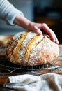 Artisan Baker Holding Freshly Baked Sourdough Bread in a Rustic Kitchen Royalty Free Stock Photo