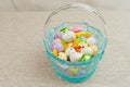 Artisan, blue, glass easter basket, filler with colorful, easter, candy Royalty Free Stock Photo