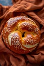 Artisan braided bread on rustic table with delicate flowers and fabric