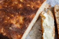 Artisan bread and slices of buttered bread, close-up. Concept of breakfast or healthy food Royalty Free Stock Photo