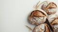 Artisan breads are presented on a white surface, surrounded by wheat and flour in a deliberate arrangement Royalty Free Stock Photo
