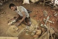 An artisan busy with making Dokra objects in a home workshop in Chhattisgarh.. Royalty Free Stock Photo