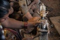 An lady artisan busy with making Dokra objects in a home workshop in Chhattisgarh.. Royalty Free Stock Photo