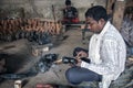An artisan busy with making Dokra objects in a home workshop in Chhattisgarh.. Royalty Free Stock Photo