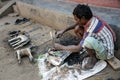 An  artisan busy with making Dokra objects in a home workshop in Chhattisgarh.. Royalty Free Stock Photo