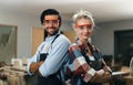 Artisan carpenter man and woman smiling looking at the camera Royalty Free Stock Photo