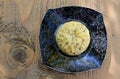 Artisan cheese with seeds in the shape of a flower on a plate