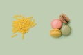 Artisan chef minimal concept. Raw macaroni on the left and four yummy macarons on the right side. Flat lay arrangement with