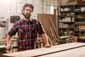 Artisan craftsman with a beard in his woodwork workshop Royalty Free Stock Photo