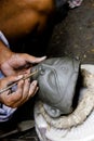 An artisan creates clay head of goddess Durga Royalty Free Stock Photo