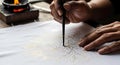 Artisan Creating Handwritten Batik with Traditional Canting Tool Royalty Free Stock Photo