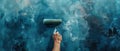 Artisan hand applying smoky blue texture with a paint roller creativity at work Royalty Free Stock Photo