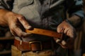 artisan handcrafting a leather belt Royalty Free Stock Photo