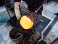 Artisan hands forming the red malleable glass on glassblower whistle Royalty Free Stock Photo